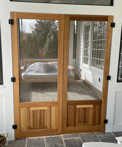 A Pair of Cedar Double Wood Screen Doors with Built in Dog Door Flap